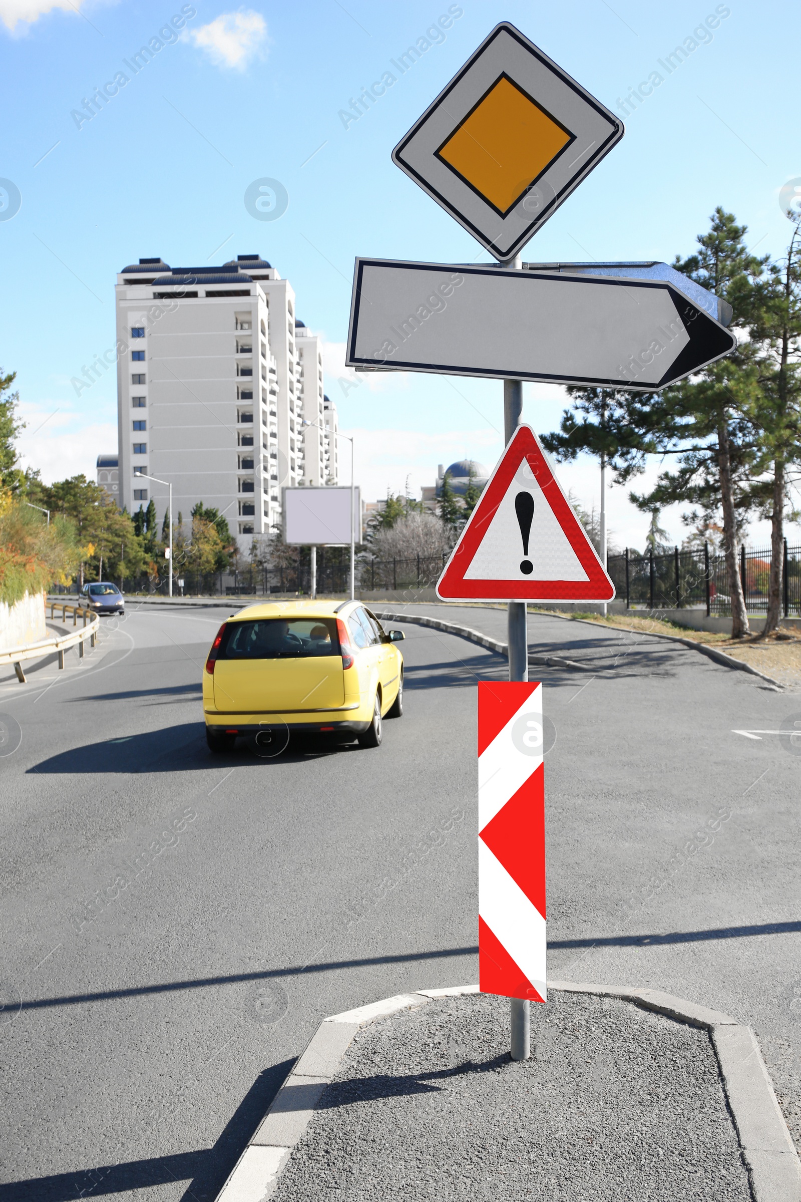 Photo of Post with different road signs on city street