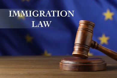 Immigration law. Judge's gavel on wooden table against European Union flag
