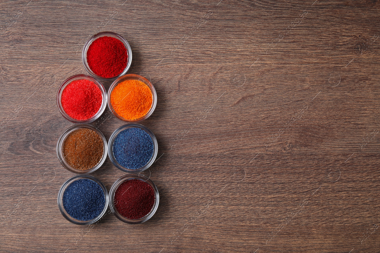 Photo of Many different food coloring on wooden table, flat lay. Space for text