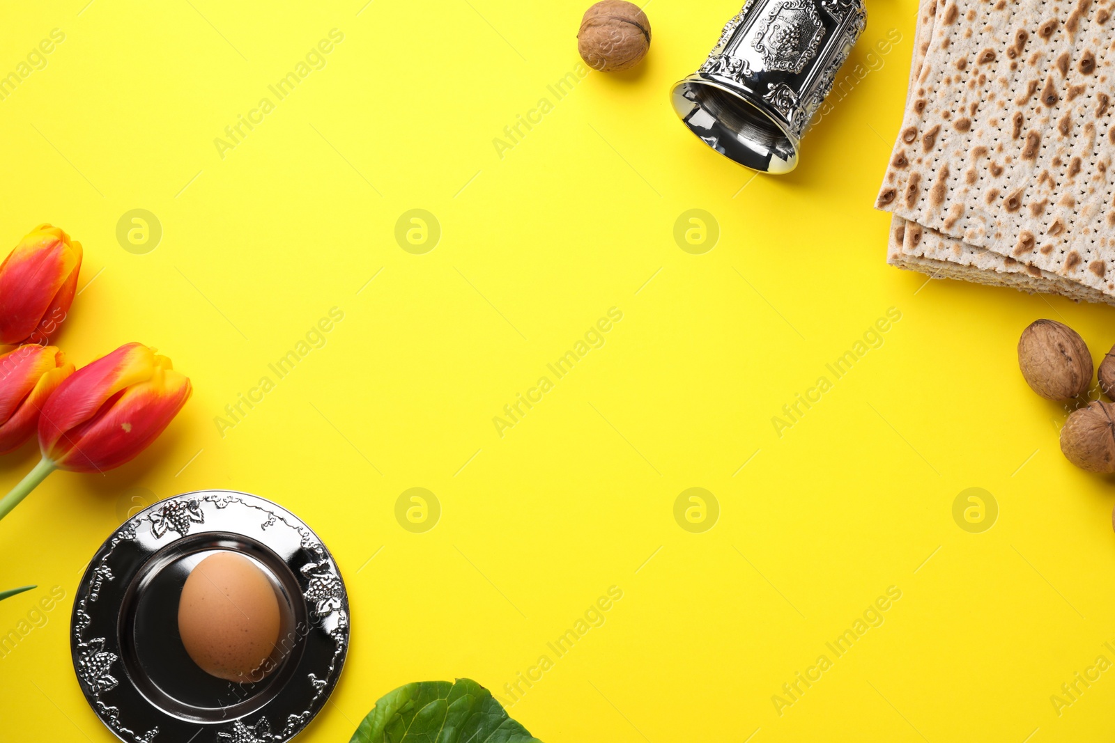 Photo of Flat lay composition with symbolic Pesach (Passover Seder) items on yellow background, space for text