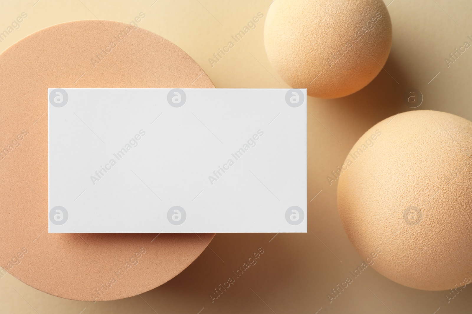 Photo of Empty business card and decorative elements on beige background, flat lay. Mockup for design