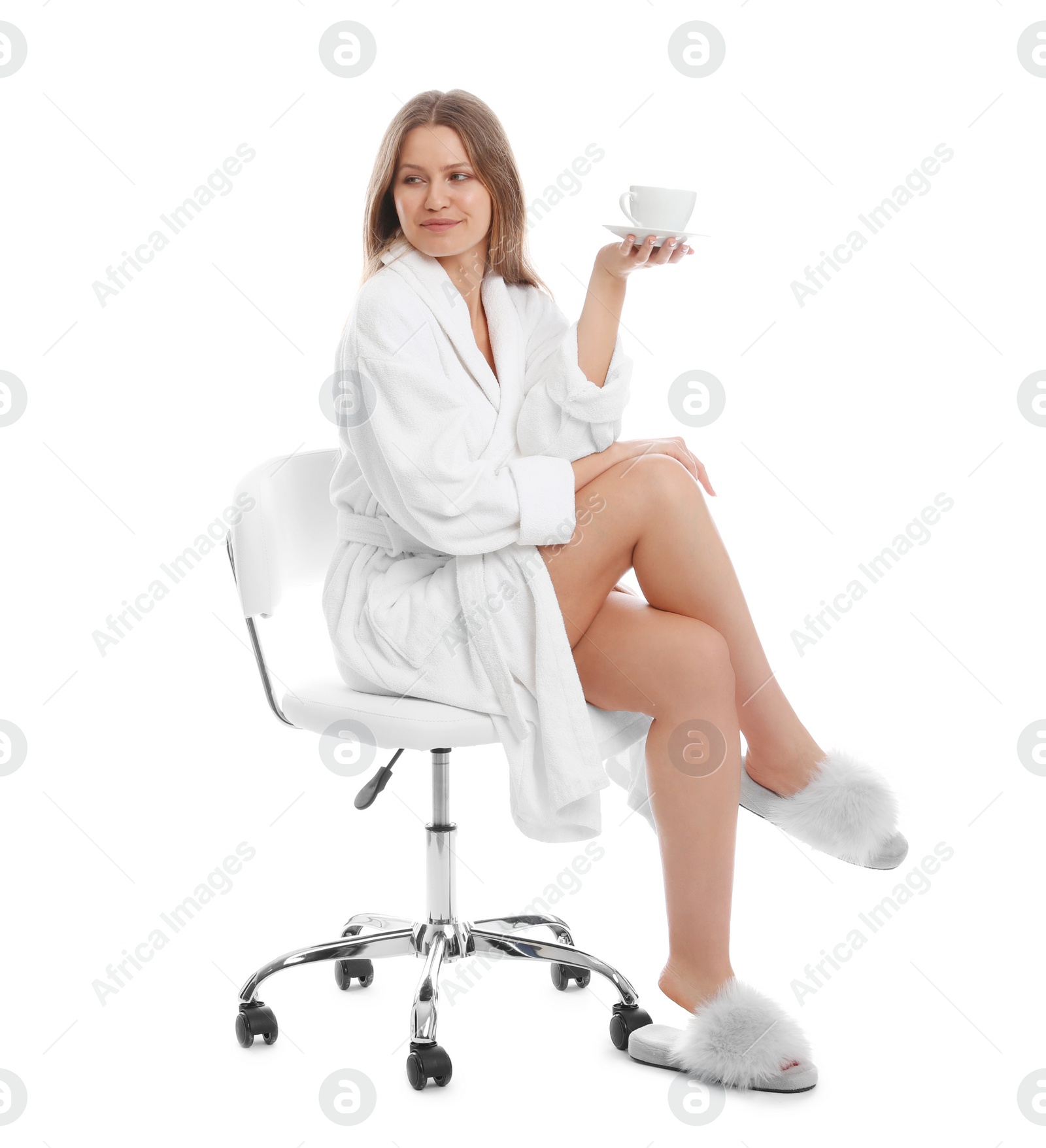 Photo of Young woman in bathrobe with cup of beverage on white background