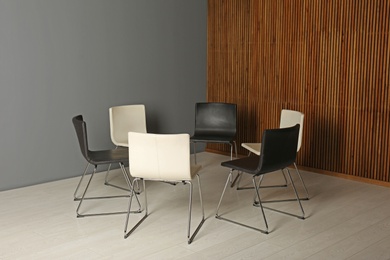 Photo of Chairs prepared for group therapy session in office. Meeting room interior