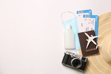 Photo of Composition with passport and protective mask on white background, top view. Travel during quarantine