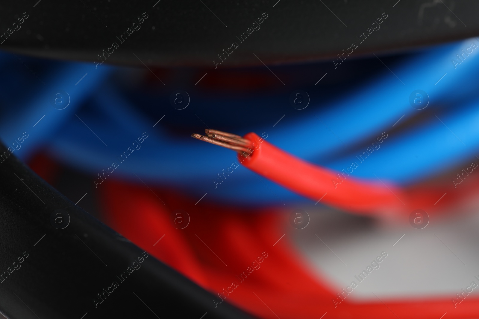 Photo of Colorful electrical wire on blurred background, closeup