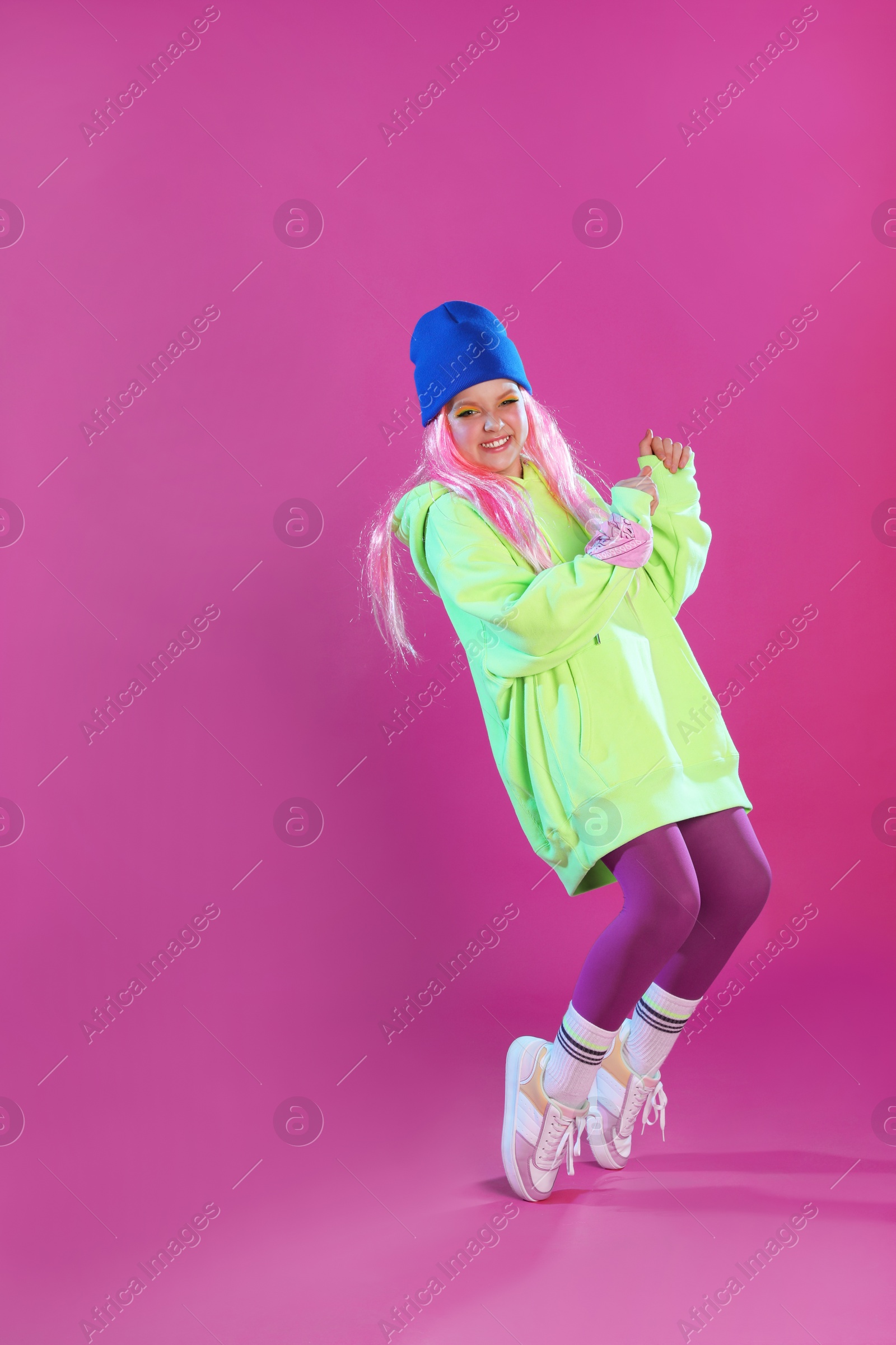 Photo of Cute indie girl jumping on violet background