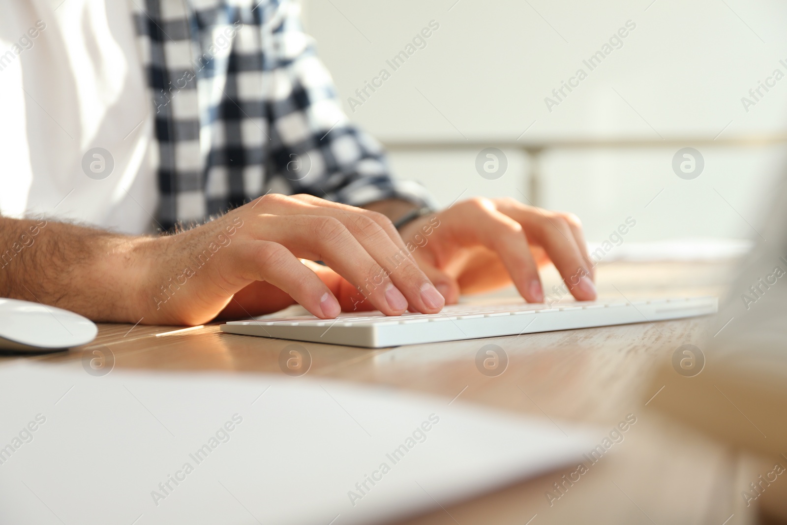 Photo of Freelancer working on computer at table indoors, closeup