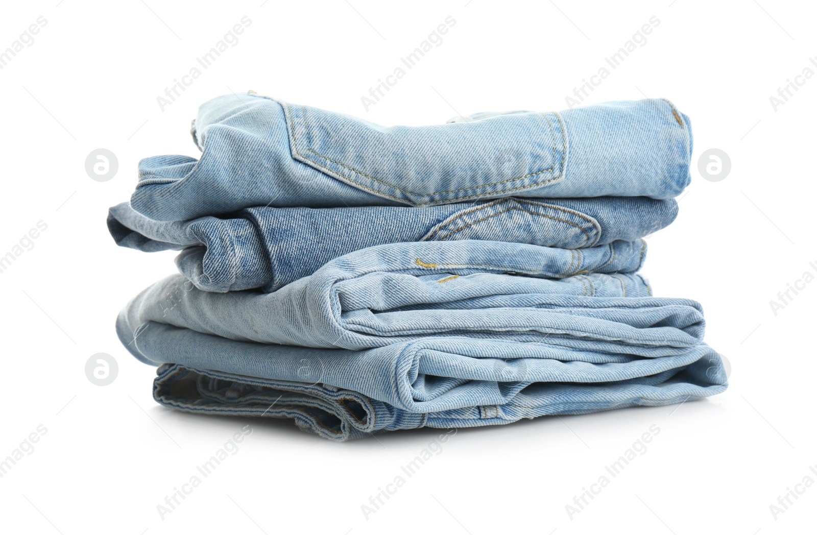Photo of Stack of folded jeans isolated on white