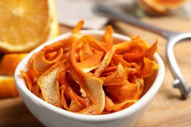 Photo of Dry orange peels on wooden table, closeup