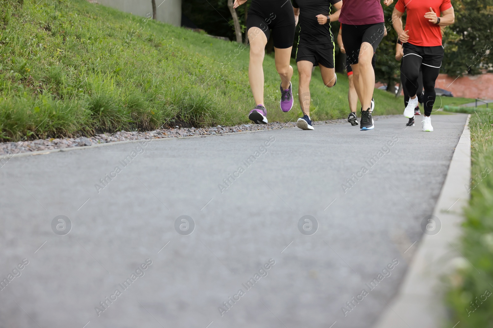 Photo of Group of people running outdoors, closeup. Space for text