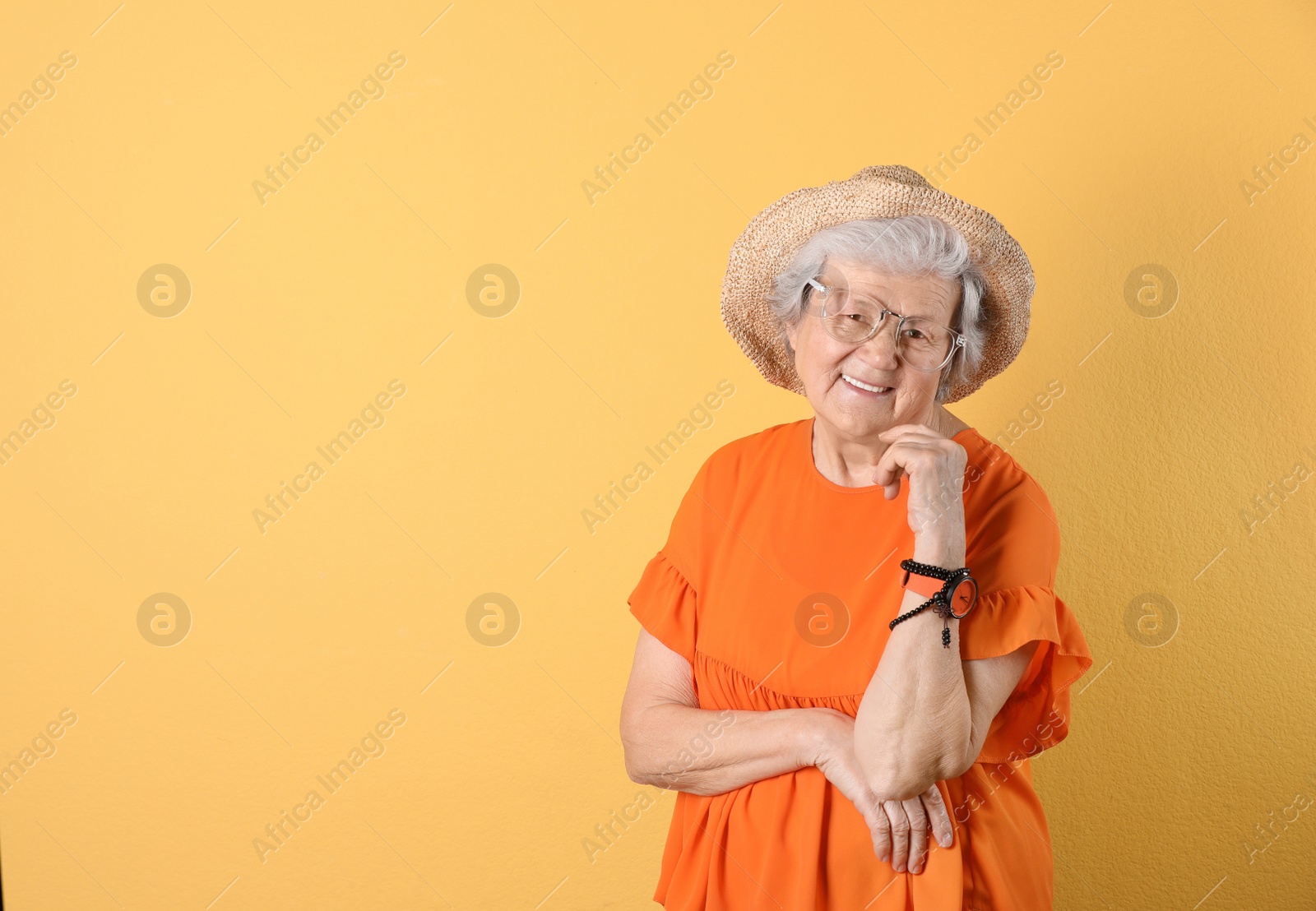 Photo of Portrait of cool grandmother on color background, space for text