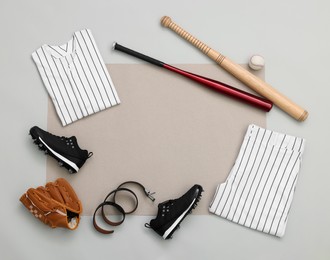 Photo of Flat lay composition with baseball uniform and sports equipment on color background