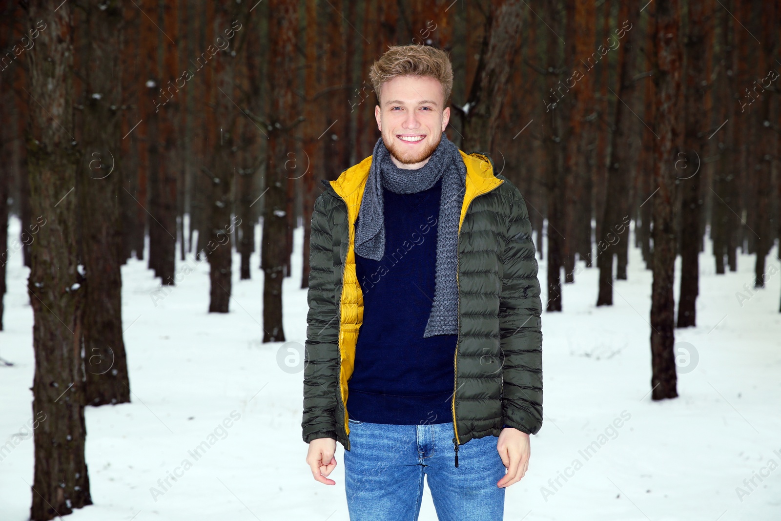 Photo of Young man posing in snowy winter forest