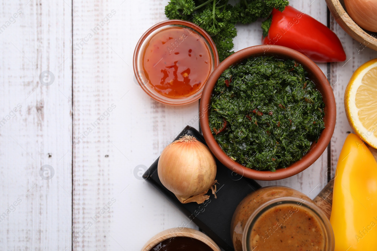 Photo of Different fresh marinades and ingredients on white wooden table, flat lay. Space for text