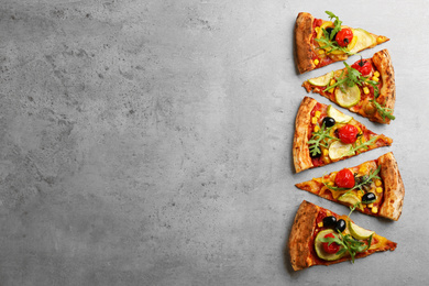 Photo of Delicious vegetable pizza on grey table, flat lay. Space for text