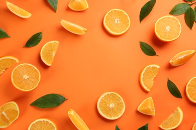 Photo of Frame of delicious orange slices on color background, flat lay. Space for text