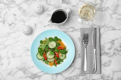 Photo of Vegetable salad and balsamic vinegar served on marble table, top view