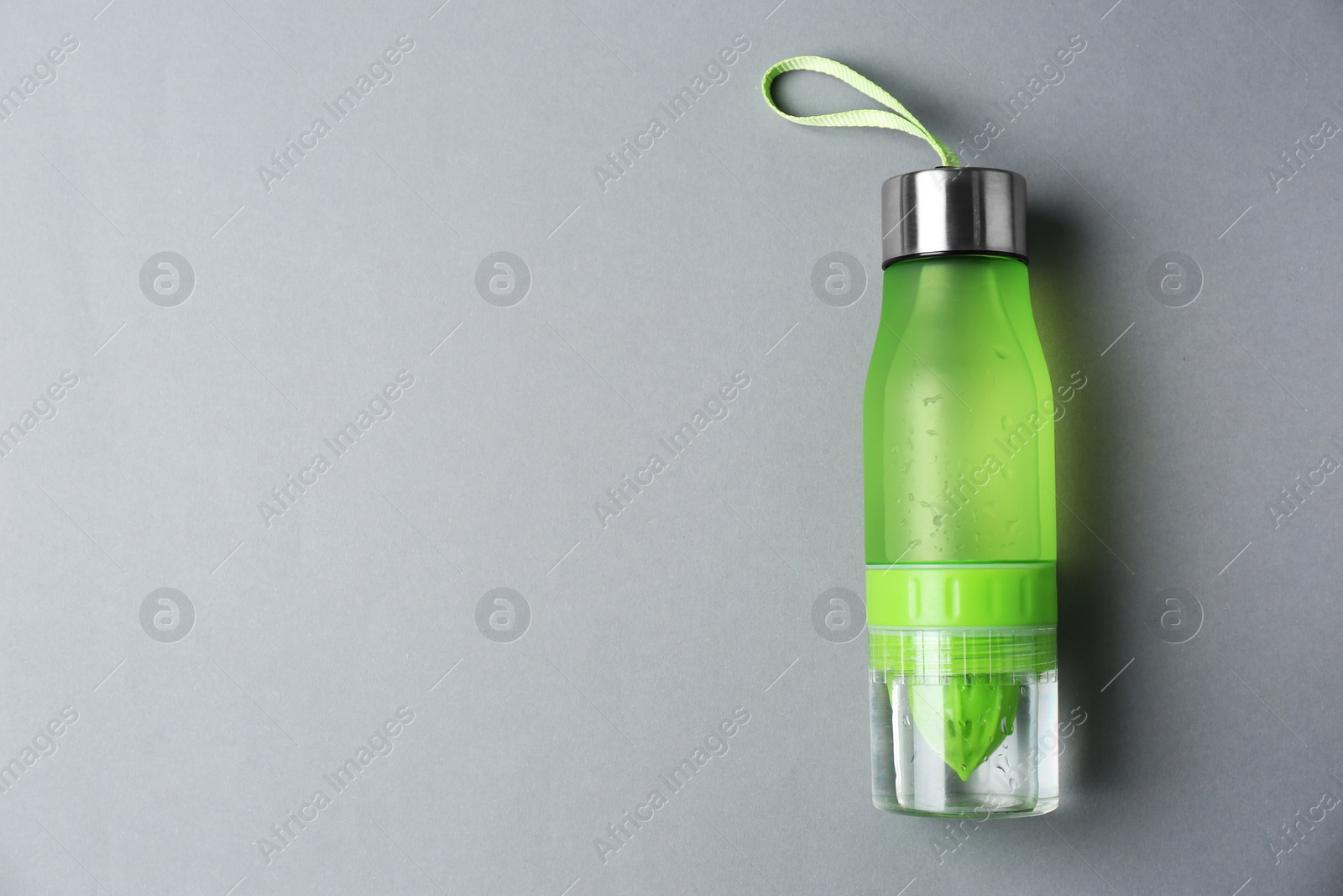 Photo of Sport bottle with space for text on color background, top view