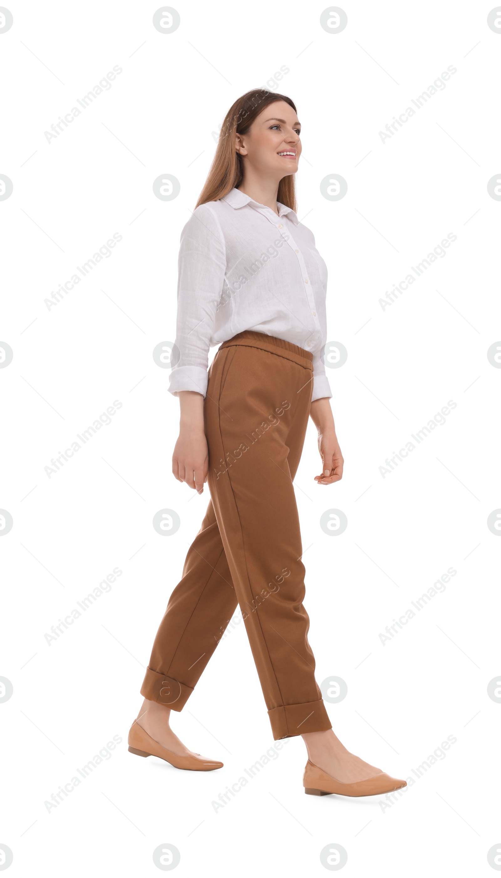 Photo of Beautiful happy businesswoman walking on white background