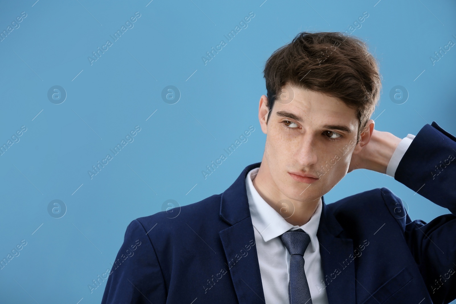 Photo of Portrait of young businessman with beautiful hair on color background