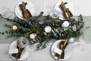 Luxury table setting with beautiful decor and blank cards. Festive dinner