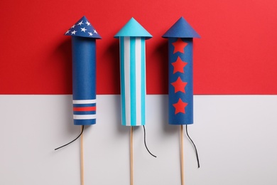Photo of Firework rockets on color background, flat lay. Festive decor
