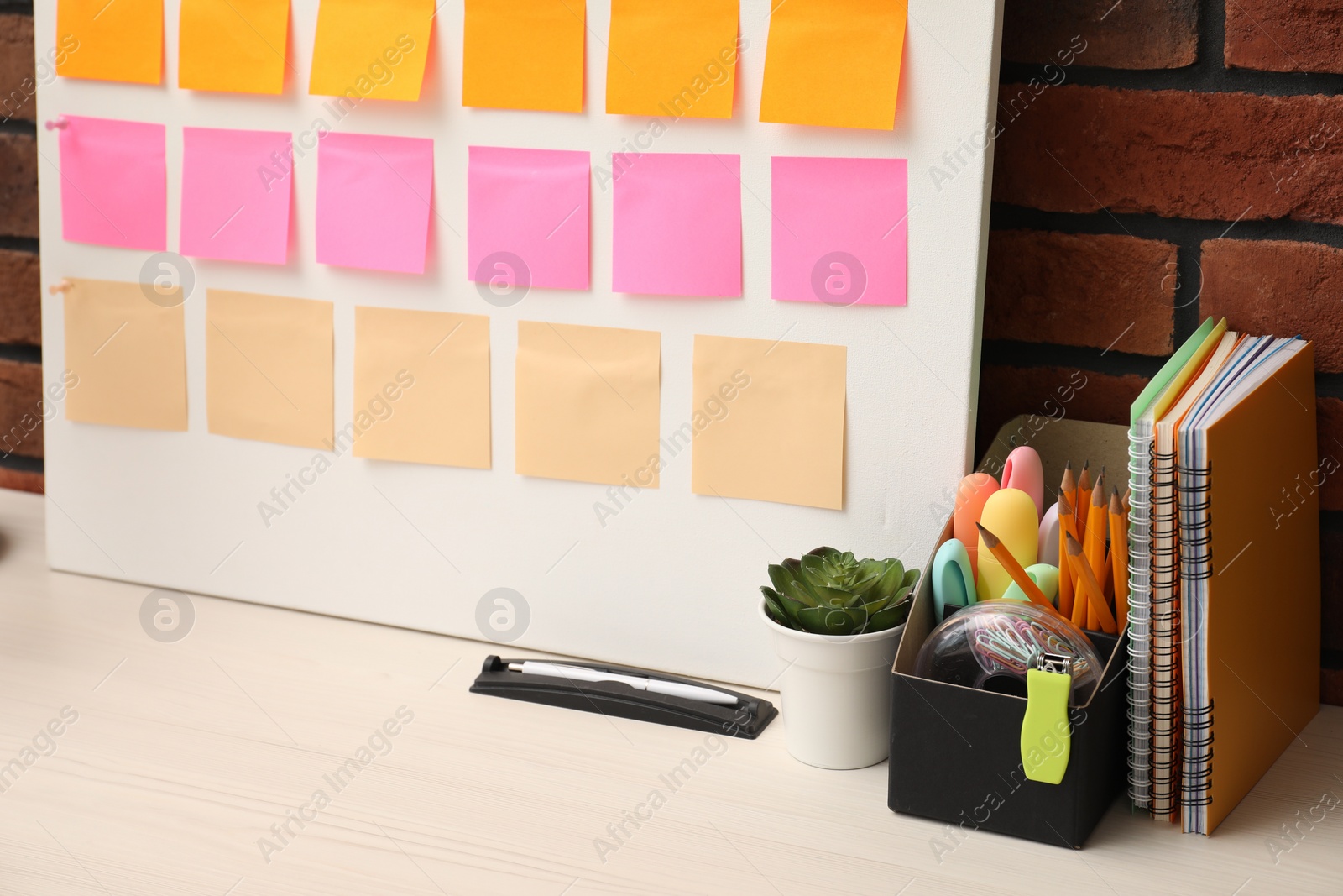 Photo of Business process planning and optimization. Workplace with colorful paper notes and other stationery on table