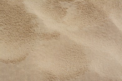 Photo of Texture of sandy beach as background, above view