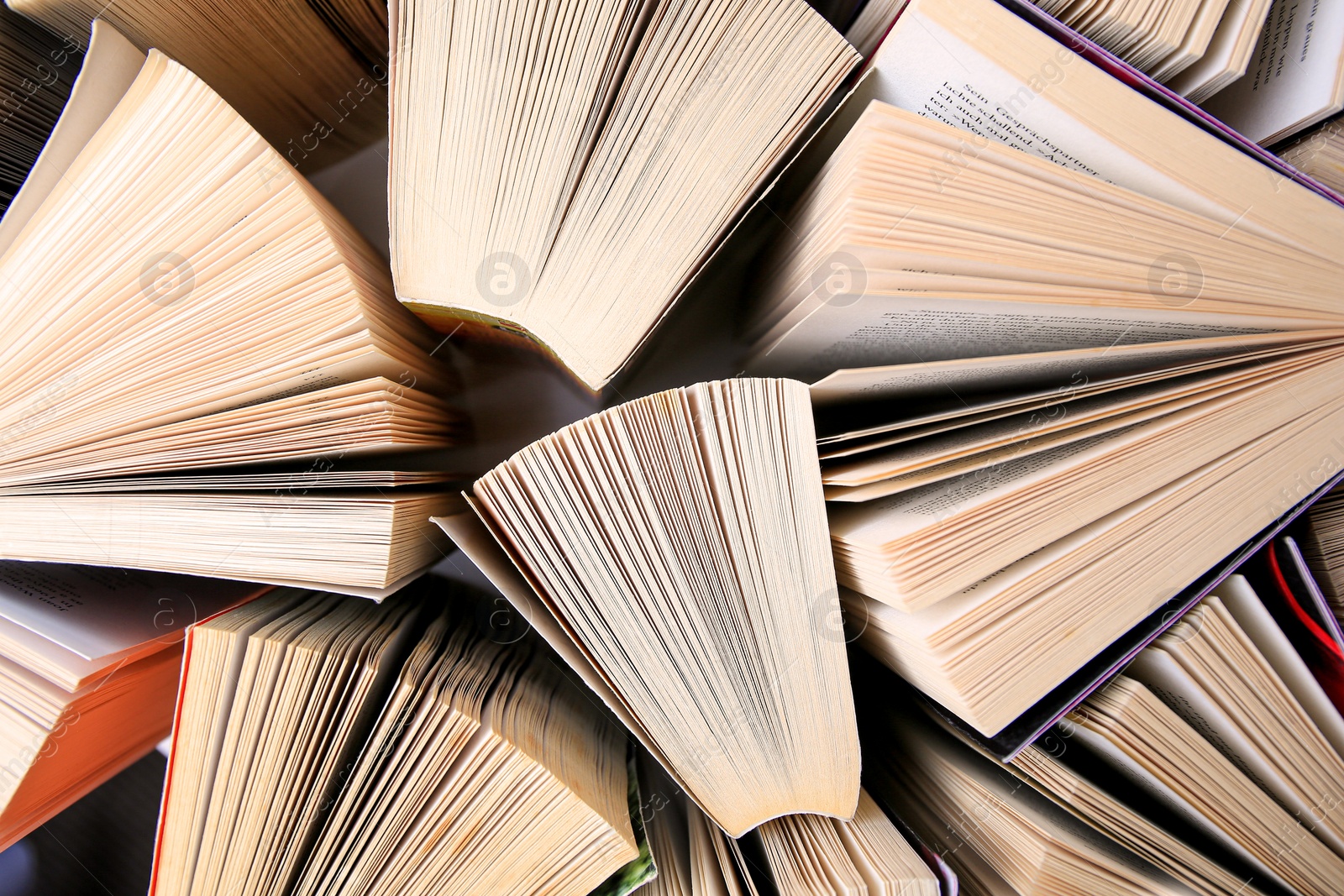 Photo of Collection of different books on white shelf, above view