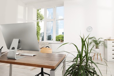 Photo of Comfortable workplace in stylish room. Home office