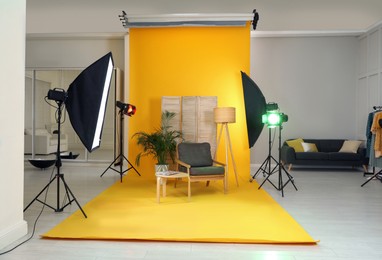 Photo of Stylish furniture in photo studio with professional equipment