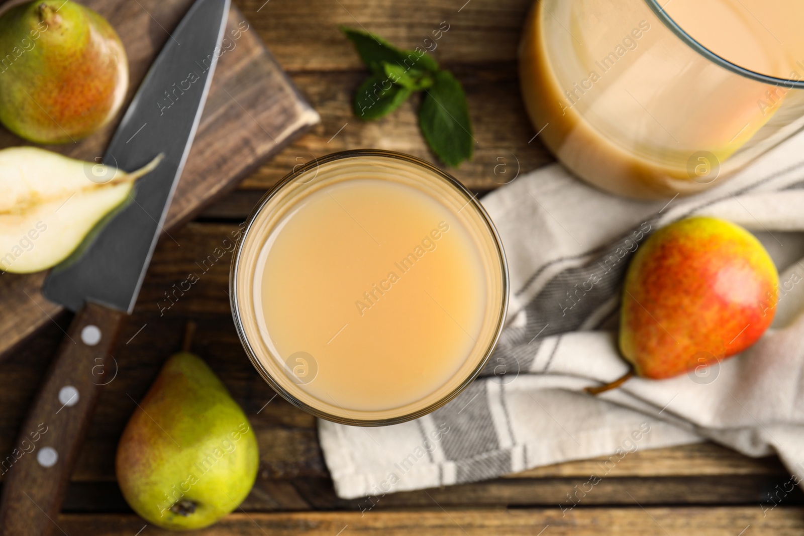 Photo of Tasty pear juice and fruits on wooden table, flat lay