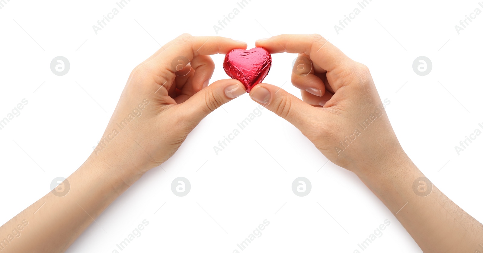 Photo of Woman holding heart shaped chocolate candy on white background, closeup