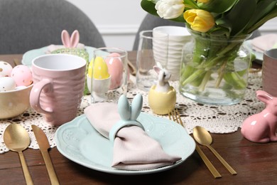 Festive table setting with napkin ring in shape of bunny ears. Easter celebration