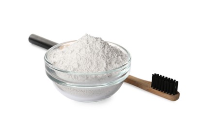 Glass bowl of tooth powder and brush on white background