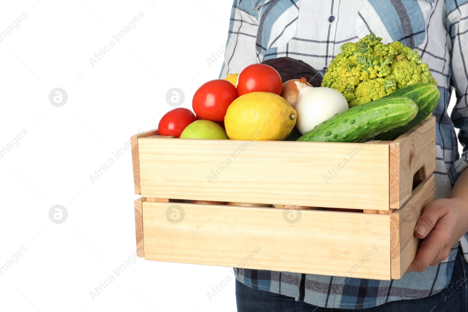 Photo of Woman holding wooden crate filled with fresh vegetables and fruits against white background, closeup