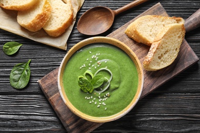 Photo of Fresh vegetable detox soup made of spinach served on table, top view