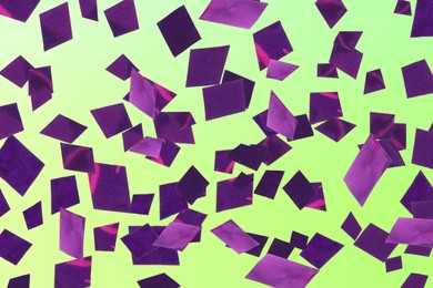Image of Shiny purple confetti falling on gradient green background