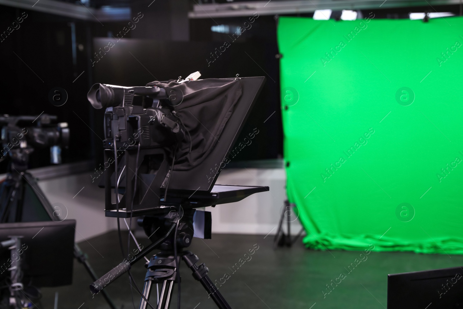 Photo of Modern video recording studio with professional equipment, focus on camera