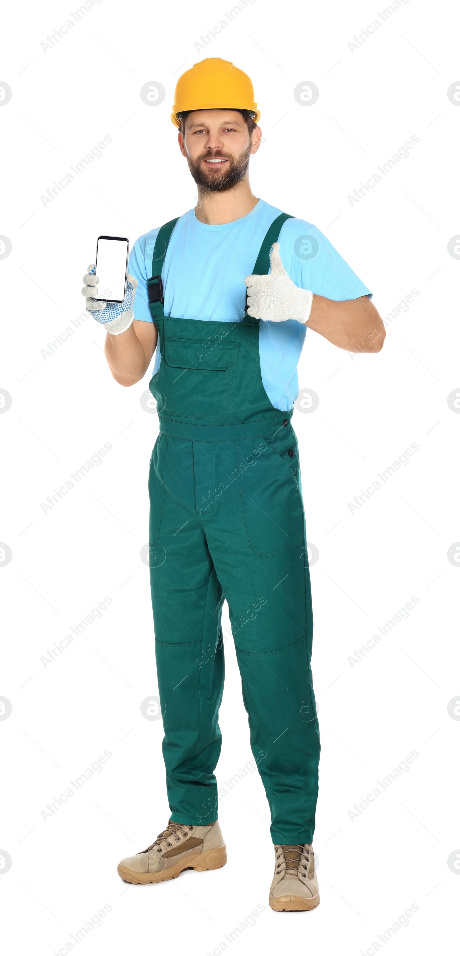 Photo of Professional repairman in uniform showing smartphone and thumbs up on white background