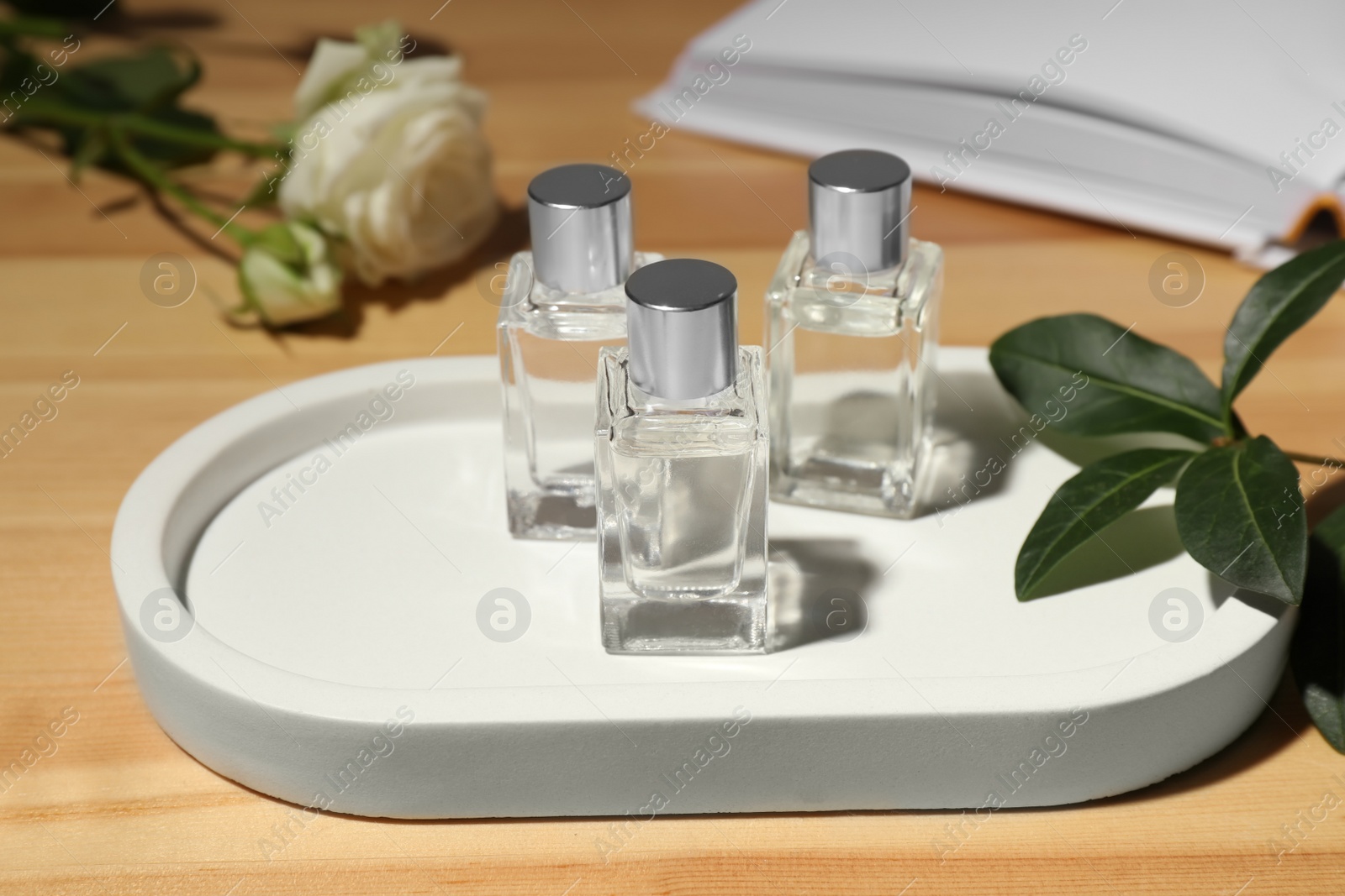 Photo of Bottles of essential oil on wooden table