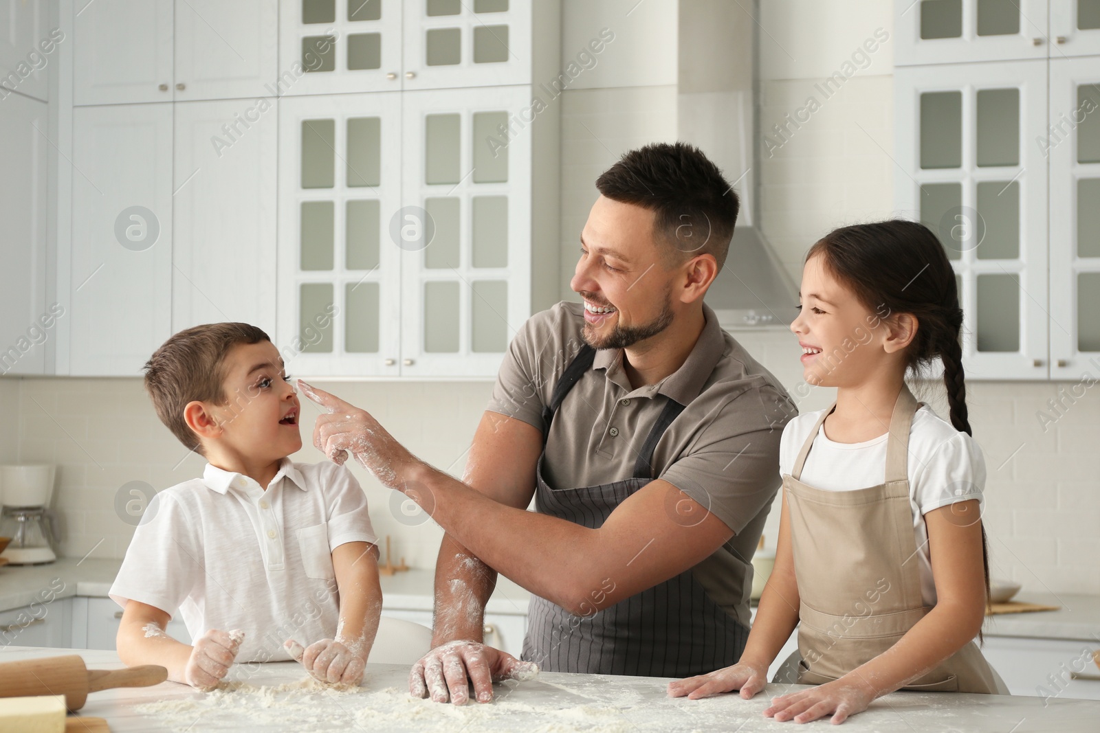 Photo of Happy family cooking together in kitchen at home