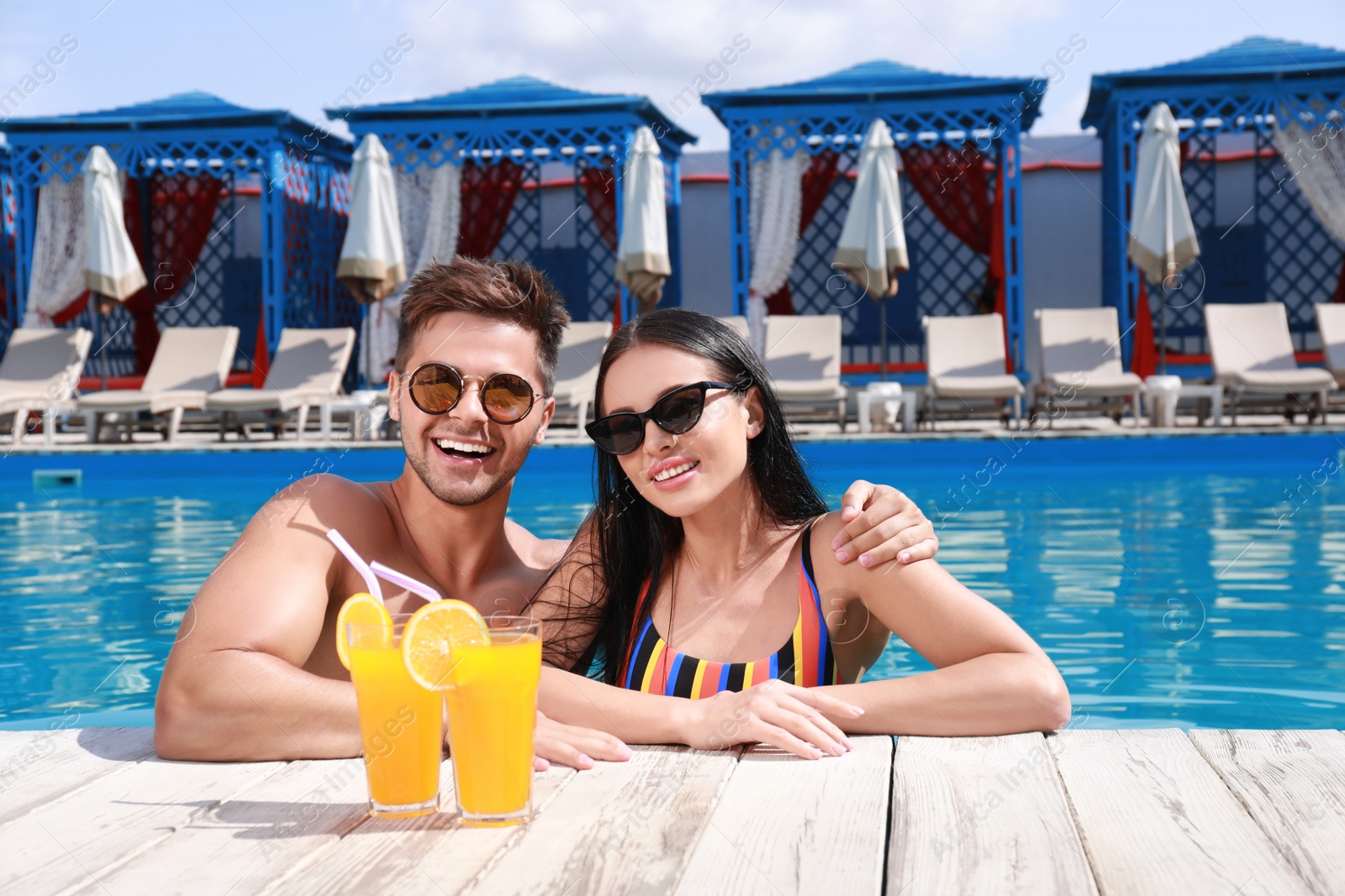 Photo of Woman in bikini with boyfriend at resort. Happy young couple