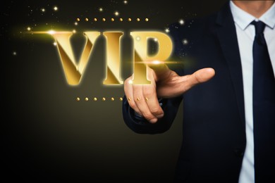 VIP member. Closeup view of man pointing at virtual abbreviation on dark background