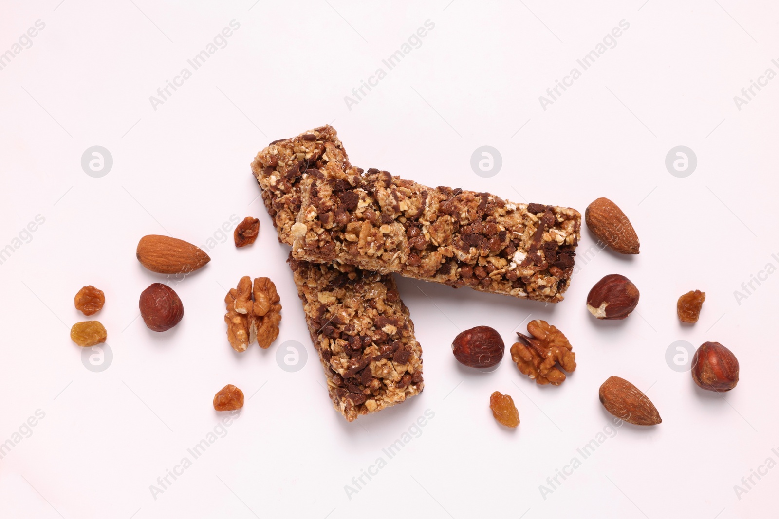 Photo of Tasty granola bars and different nuts isolated on white, top view