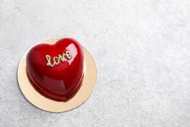 Photo of St. Valentine's Day. Delicious heart shaped cake on light table, top view. Space for text