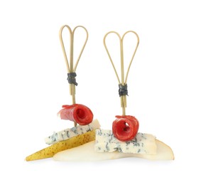 Photo of Tasty canapes with pears, blue cheese and prosciutto isolated on white