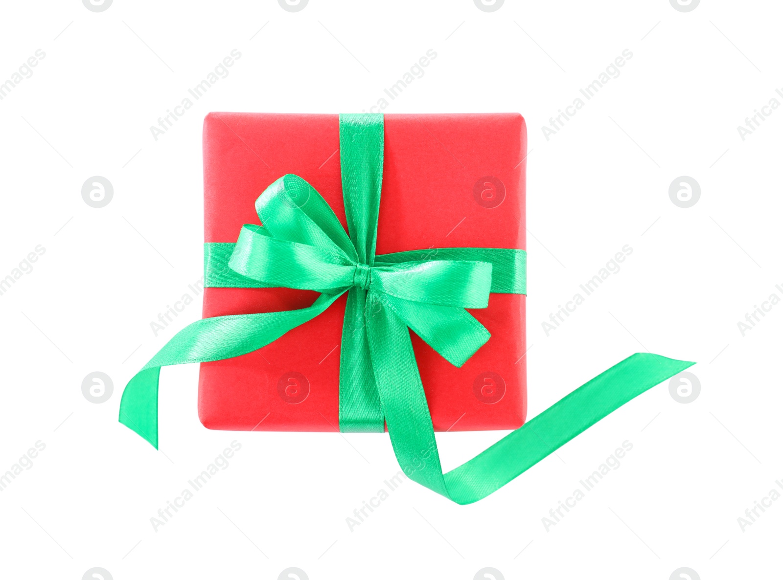 Photo of Christmas gift box decorated with ribbon bow on white background, top view