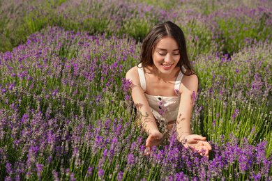 Photo of Young woman in lavender field on summer day