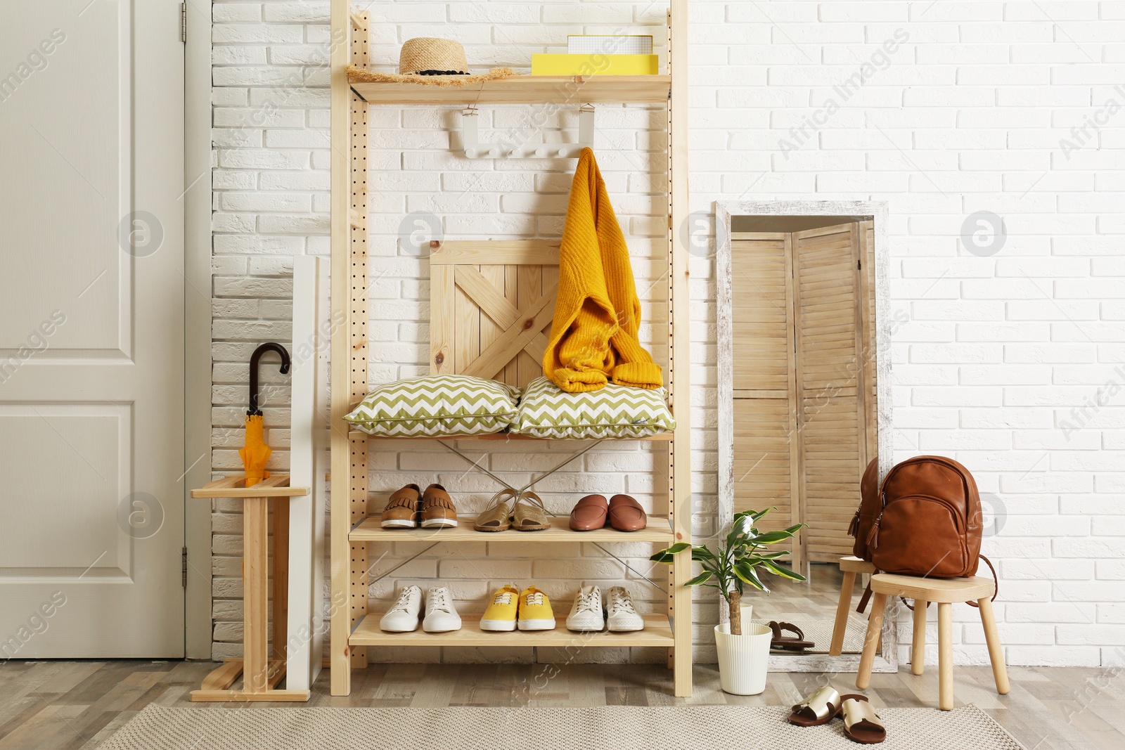 Photo of Cozy hallway interior with wooden shelving unit. Stylish design idea